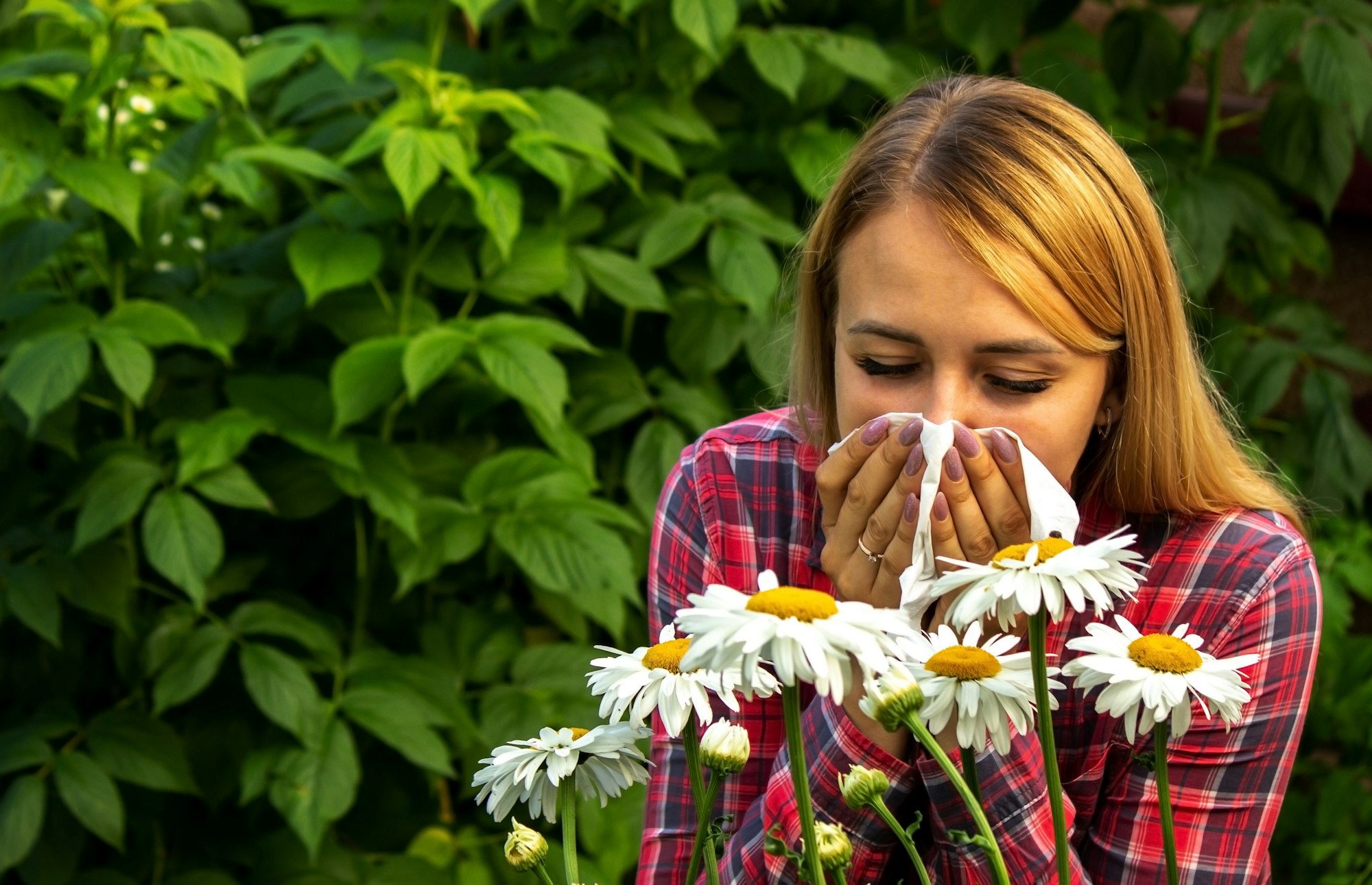 Girl's allergy to flowers. Selective focus